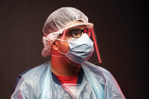 Angel Pulido in mask and nurse scrubs