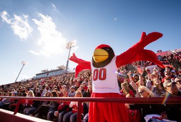 A mascot with its hands in the air.