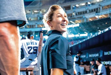 Amanda Sartoris in a baseball dugout