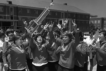 Members of the 1969 Redbird softball team celebrate their runners-up finish in the first Women's College World Series. (Courtesy of University Archives)