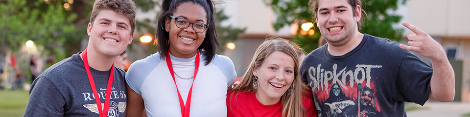 Four students posed on the Quad during a Preview event.